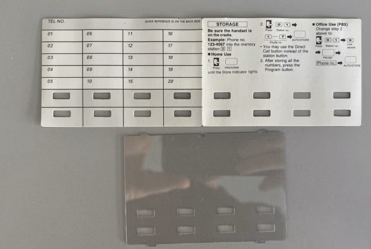 Panasonic phone with flipped label card showing fresh white surface