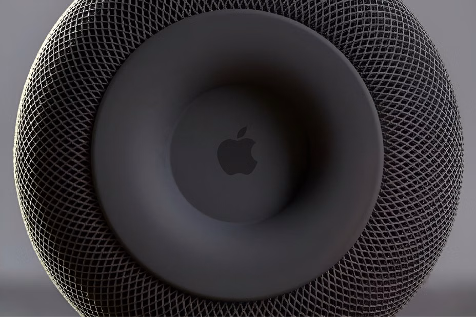 Apple logo centered on the circular top surface of a black HomePod